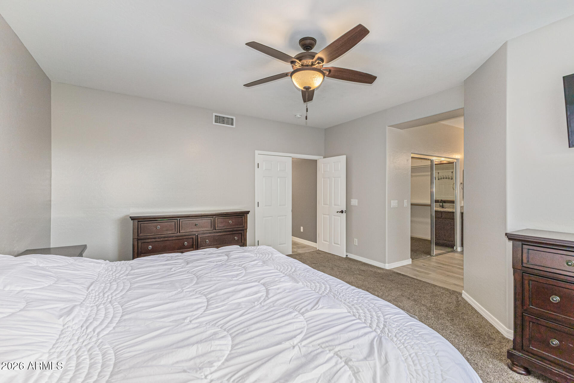 2500 East Milky Way Gilbert, AZ 85295 - Photo 17 of 33 a bedroom with a large bed and a ceiling fan