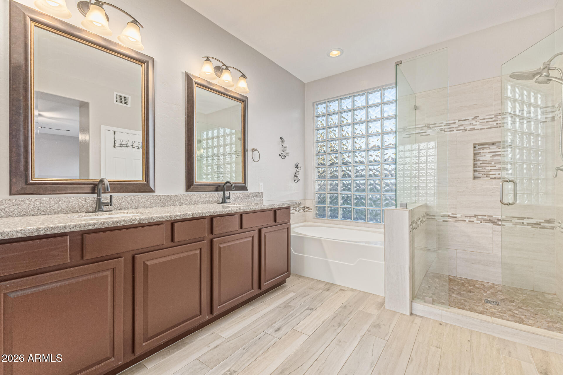 2500 East Milky Way Gilbert, AZ 85295 - Photo 18 of 33 a bathroom with a double vanity sink a large mirror and a bathtub
