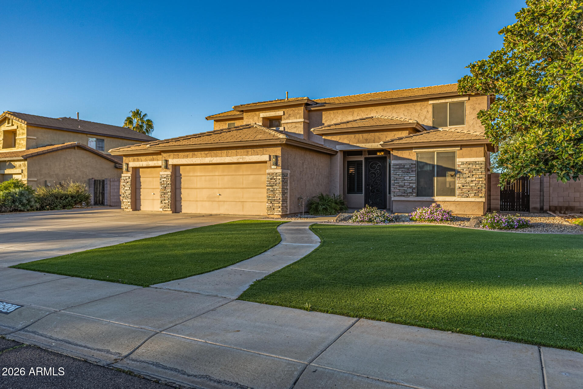 2500 East Milky Way Gilbert, AZ 85295 - Photo 3 of 33 a front view of a house with a garden and pathway