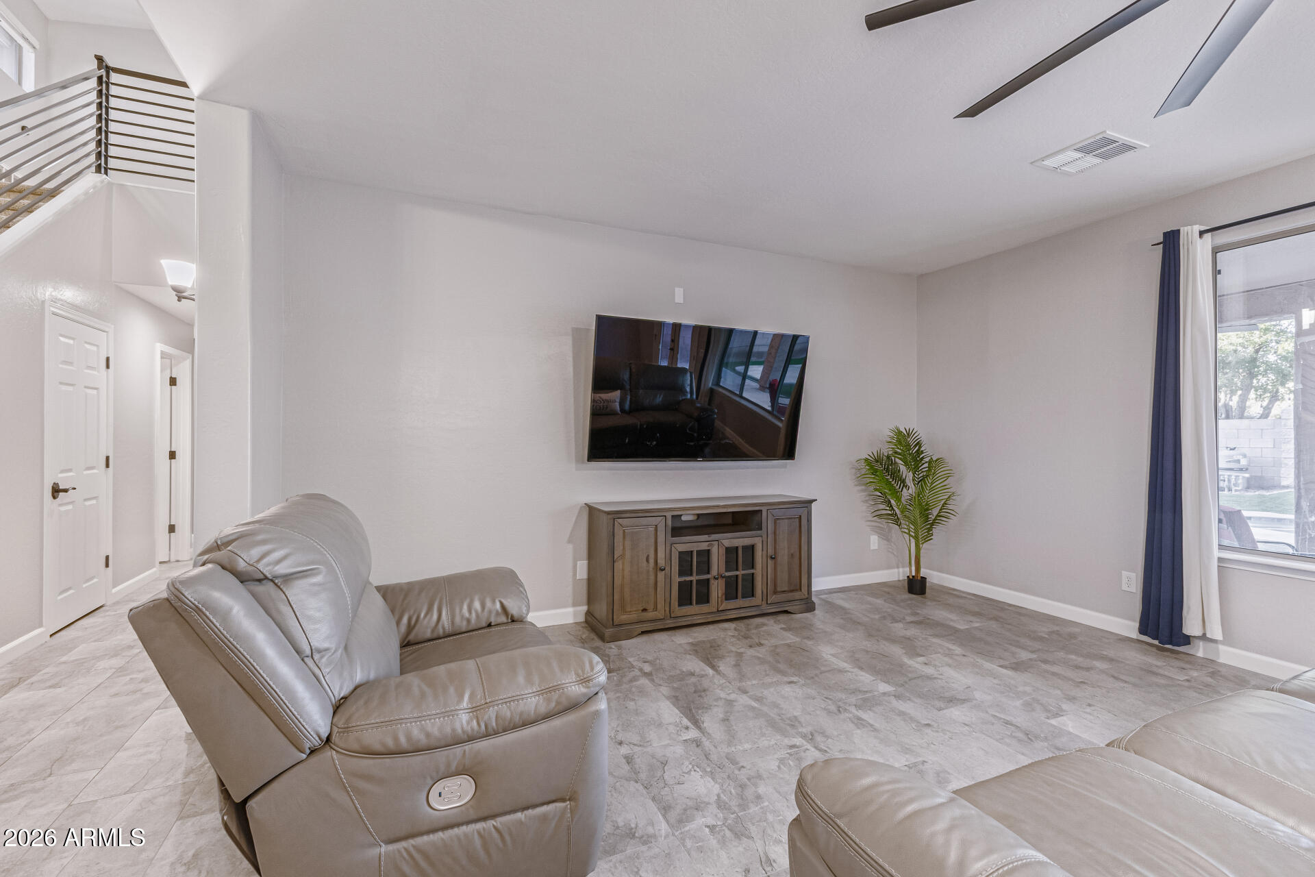 2500 East Milky Way Gilbert, AZ 85295 - Photo 5 of 33 a living room with furniture a flat screen tv and a fireplace