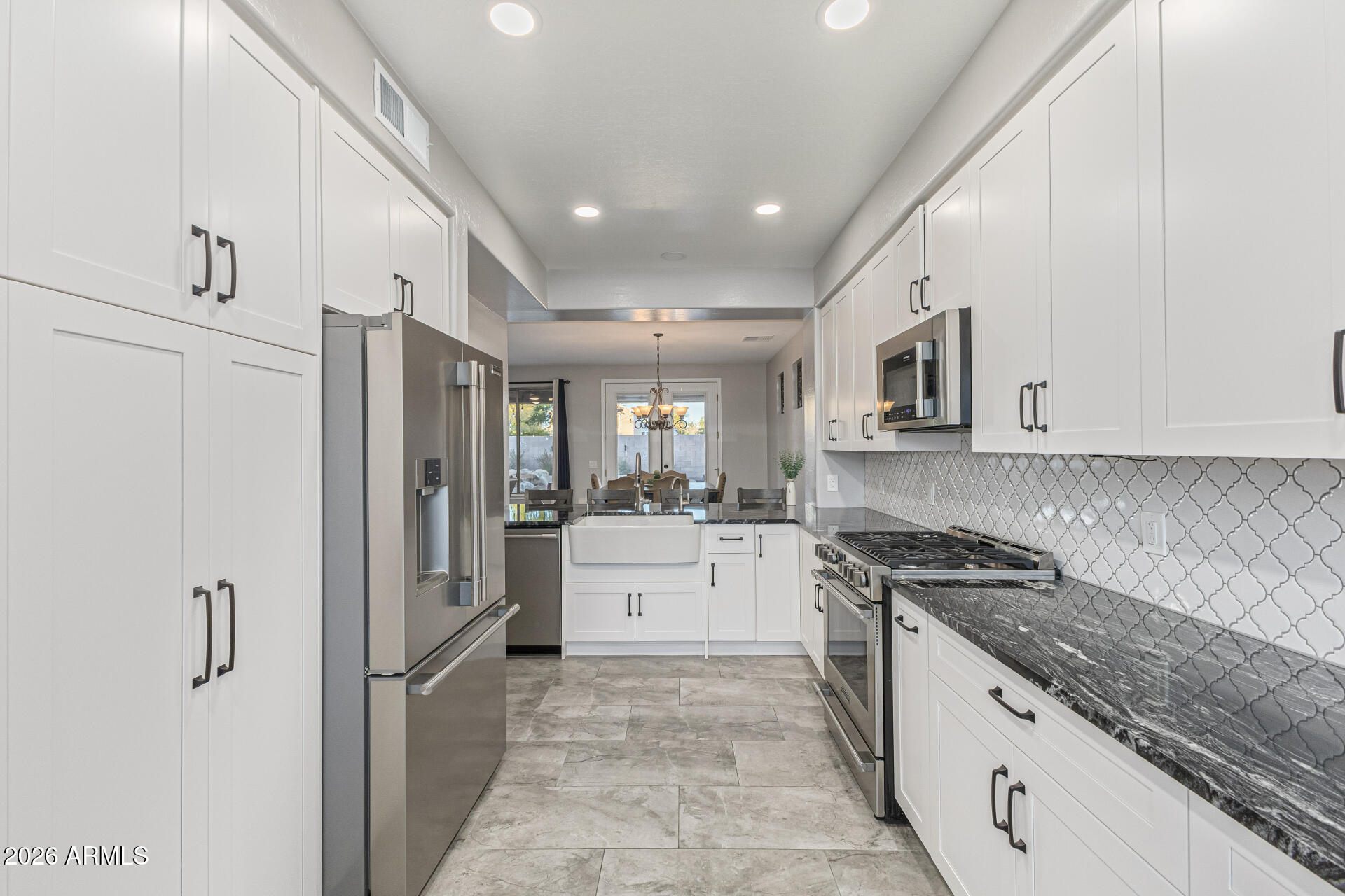 2500 East Milky Way Gilbert, AZ 85295 - Photo 9 of 33 a kitchen with a refrigerator and a stove top oven