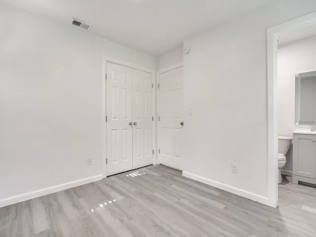 an empty room with wooden floor
