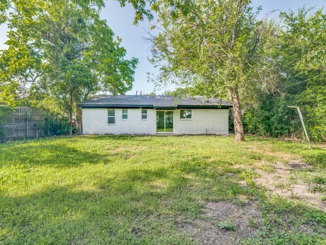 a front view of house with yard and trees