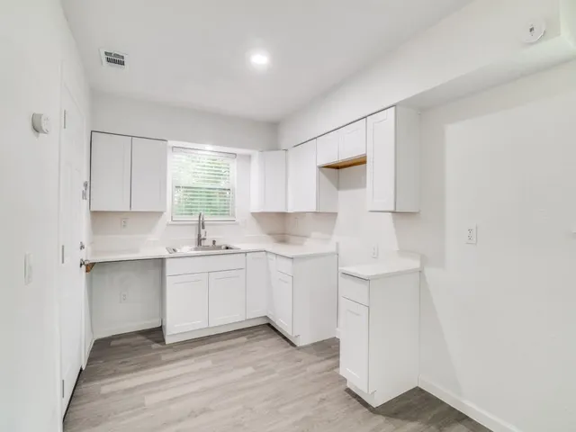 a kitchen with a sink cabinets and window
