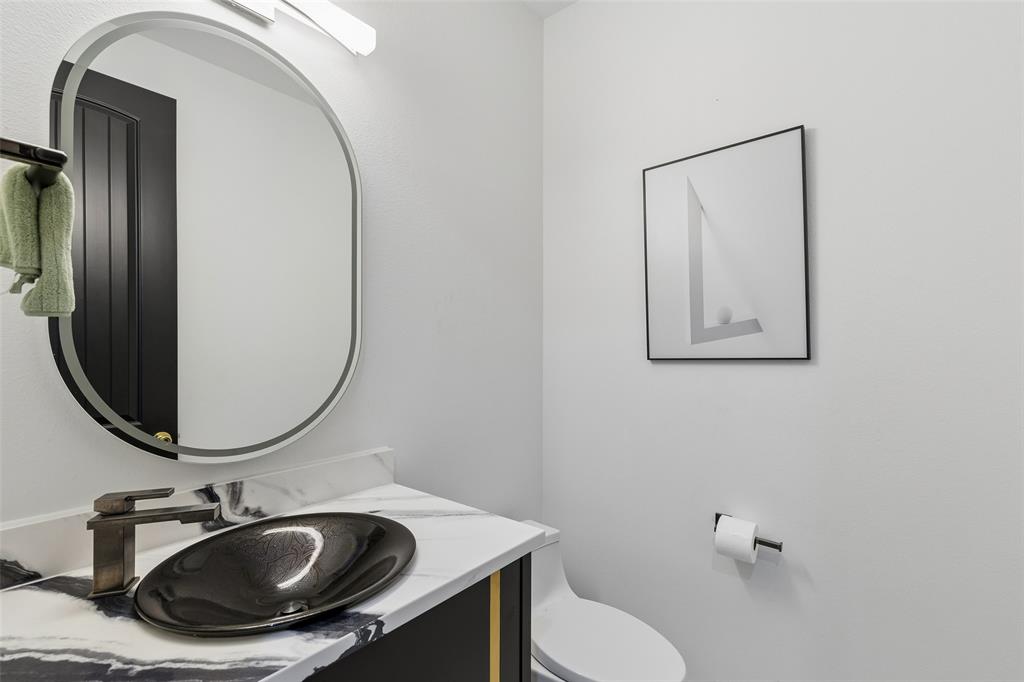 1053 Sedalia Road Van Alstyne, TX 75495 - Photo 24 of 40 a bathroom with a sink mirror and toilet