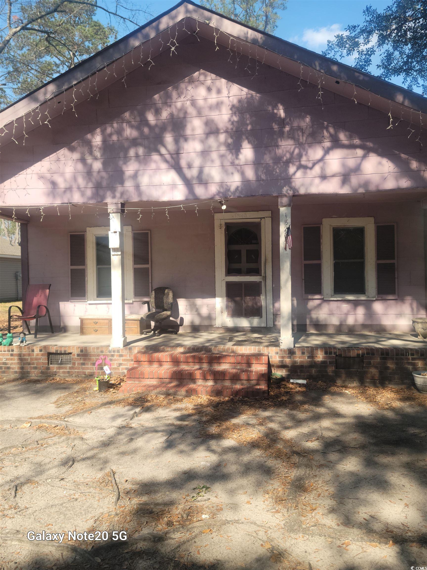 Rear view of house featuring a porch
