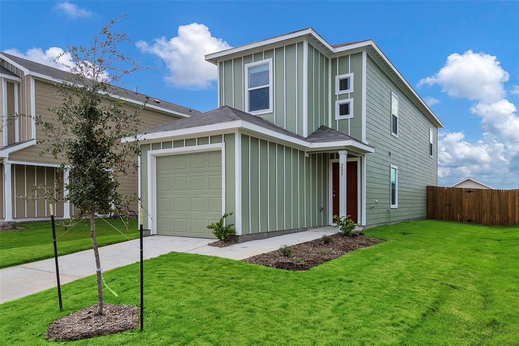 209 Boxberry Way Princeton, TX 75407 - Photo 2 of 34 a front view of a house with a garden and plants
