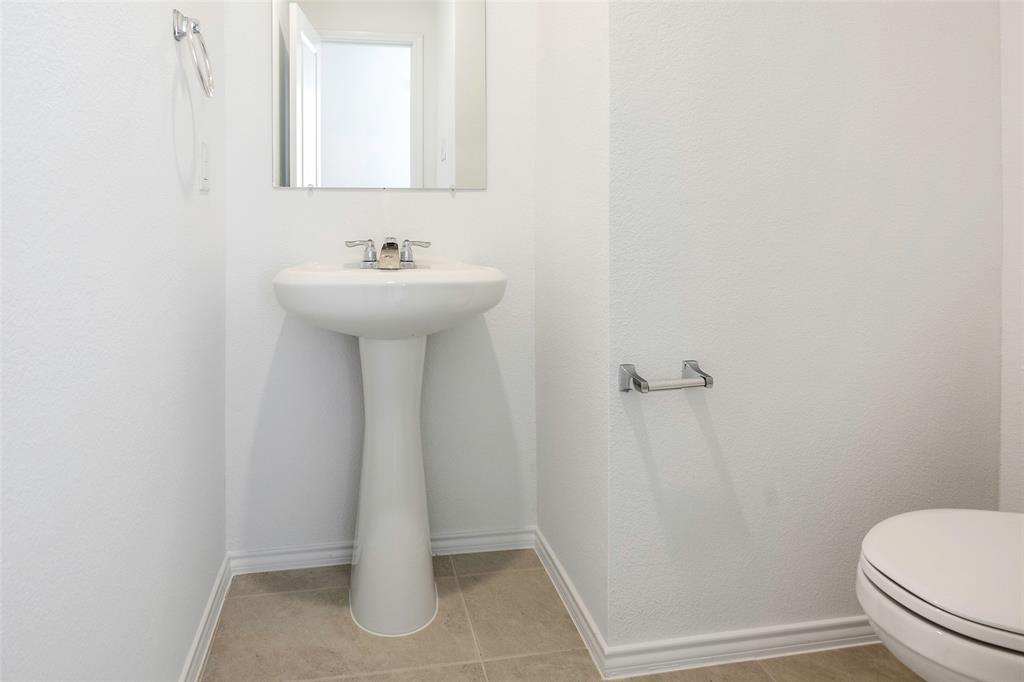 209 Boxberry Way Princeton, TX 75407 - Photo 9 of 34 a bathroom with a sink toilet and a mirror