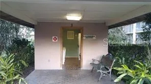 a view of a porch with chairs and potted plants