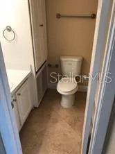 a bathroom with a toilet a sink and a mirror