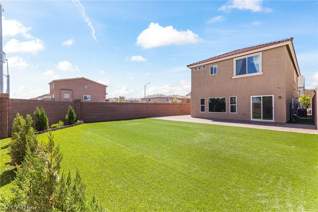 5510 Ripple Ridge Avenue Las Vegas, NV 89139 - Photo 42 of 45 Enjoy the expansive artificial turf in this private backyard, perfect for recreation and relaxation.