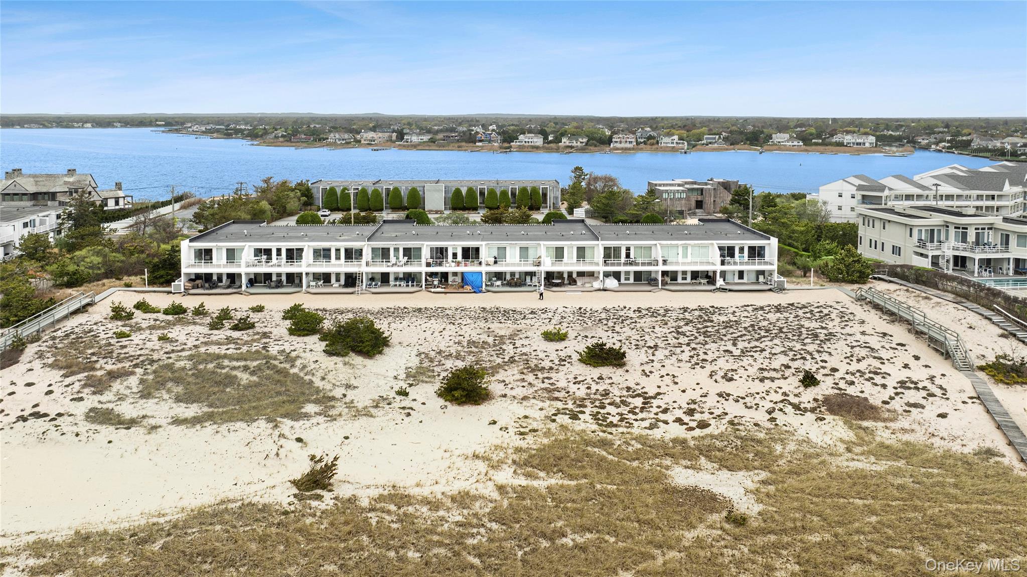 279 Dune Road, Unit 2 Westhampton Beach, NY 11978 - Photo 41 of 45 a view of a building with a lake view