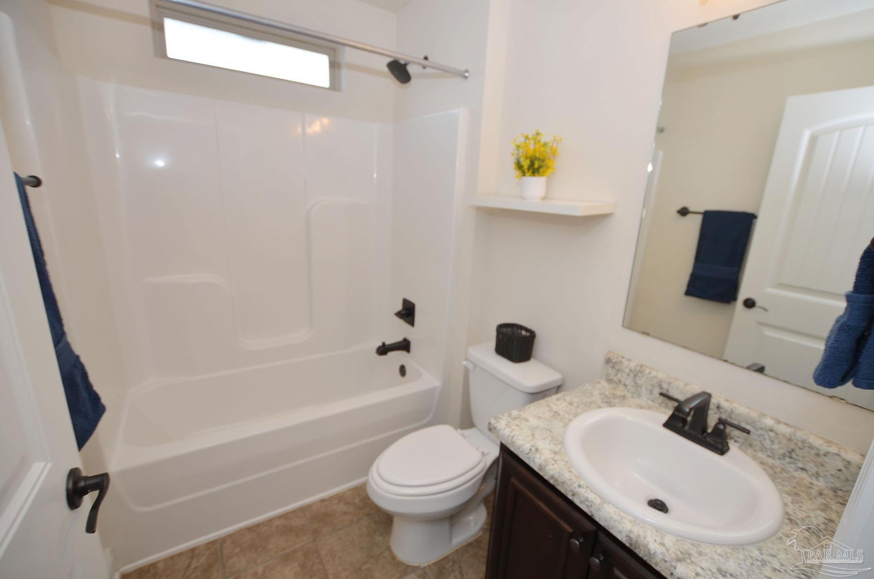 5709 Mill Stream Way Pace, FL 32571 - Photo 34 of 48 a bathroom with a sink toilet and shower