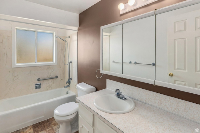 15295 North 5400th Street West Riverside, UT 84334 - Photo 28 of 54 Vanity with integrated sink, three-door mirrored medicine cabinet, white bathtub with grab bars, and a window