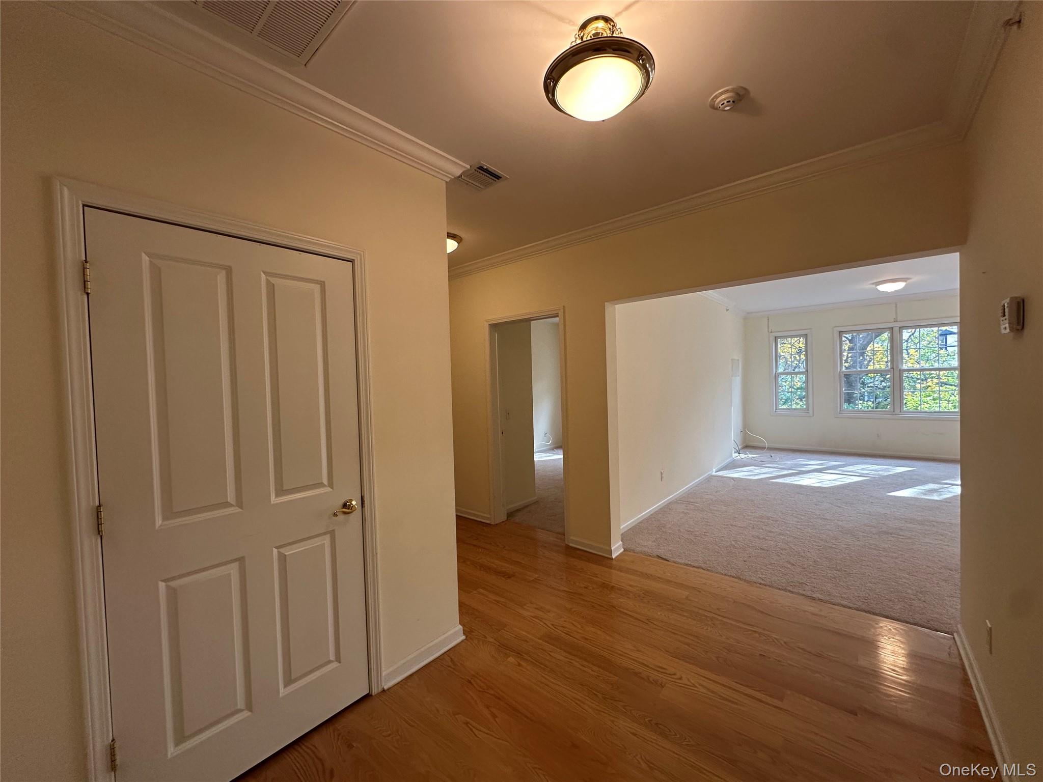 75 Quaker Avenue, Unit 315 Cornwall, NY 12518 - Photo 14 of 48 an empty room with wooden floor and windows