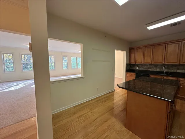a kitchen with granite countertop wooden cabinets and a granite counter tops