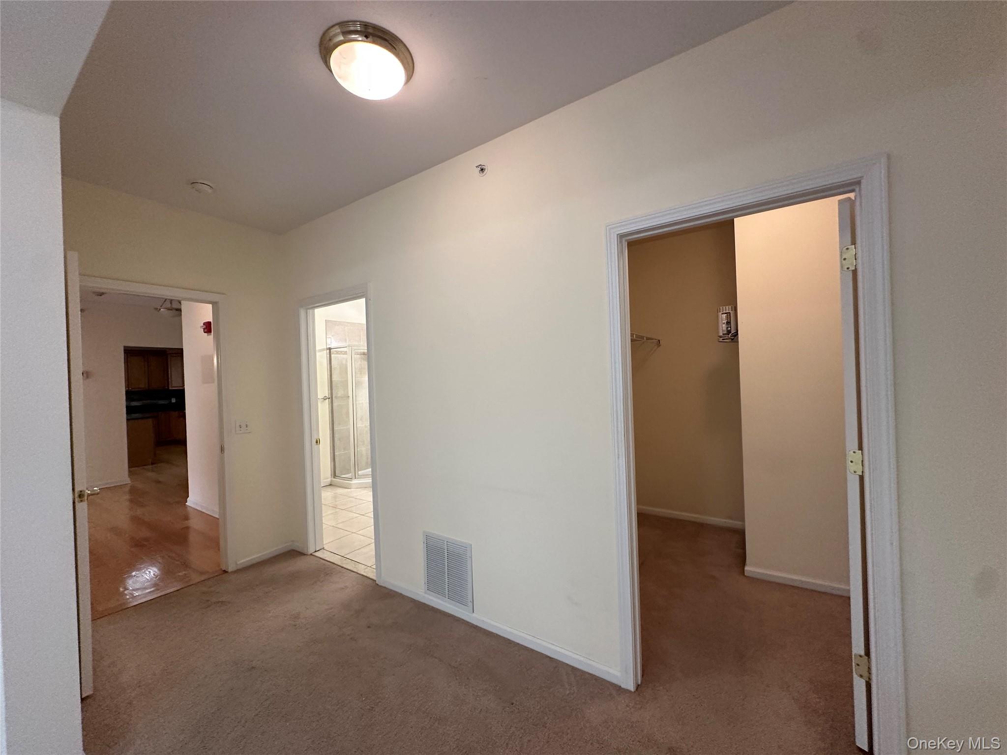 75 Quaker Avenue, Unit 315 Cornwall, NY 12518 - Photo 32 of 48 an empty room with closet and windows