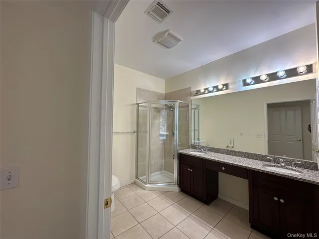 a bathroom with a double vanity sink and mirror