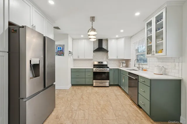 a kitchen with stainless steel appliances granite countertop a stove sink and cabinets
