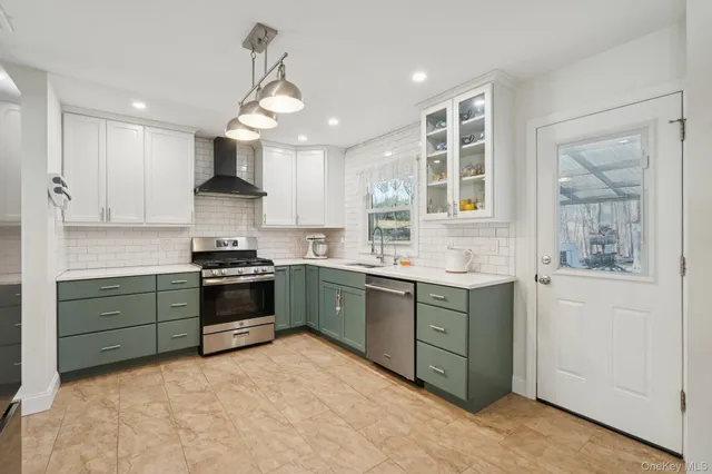 a kitchen with stainless steel appliances a refrigerator sink and stove