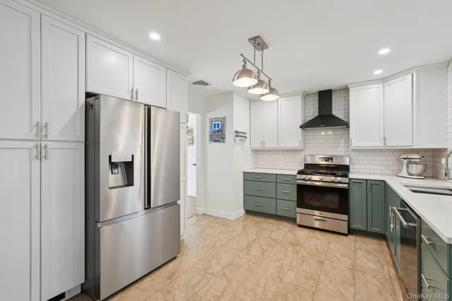 a very nice looking dining room with kitchen island granite countertop a sink dishwasher a dining table and chairs with wooden floor