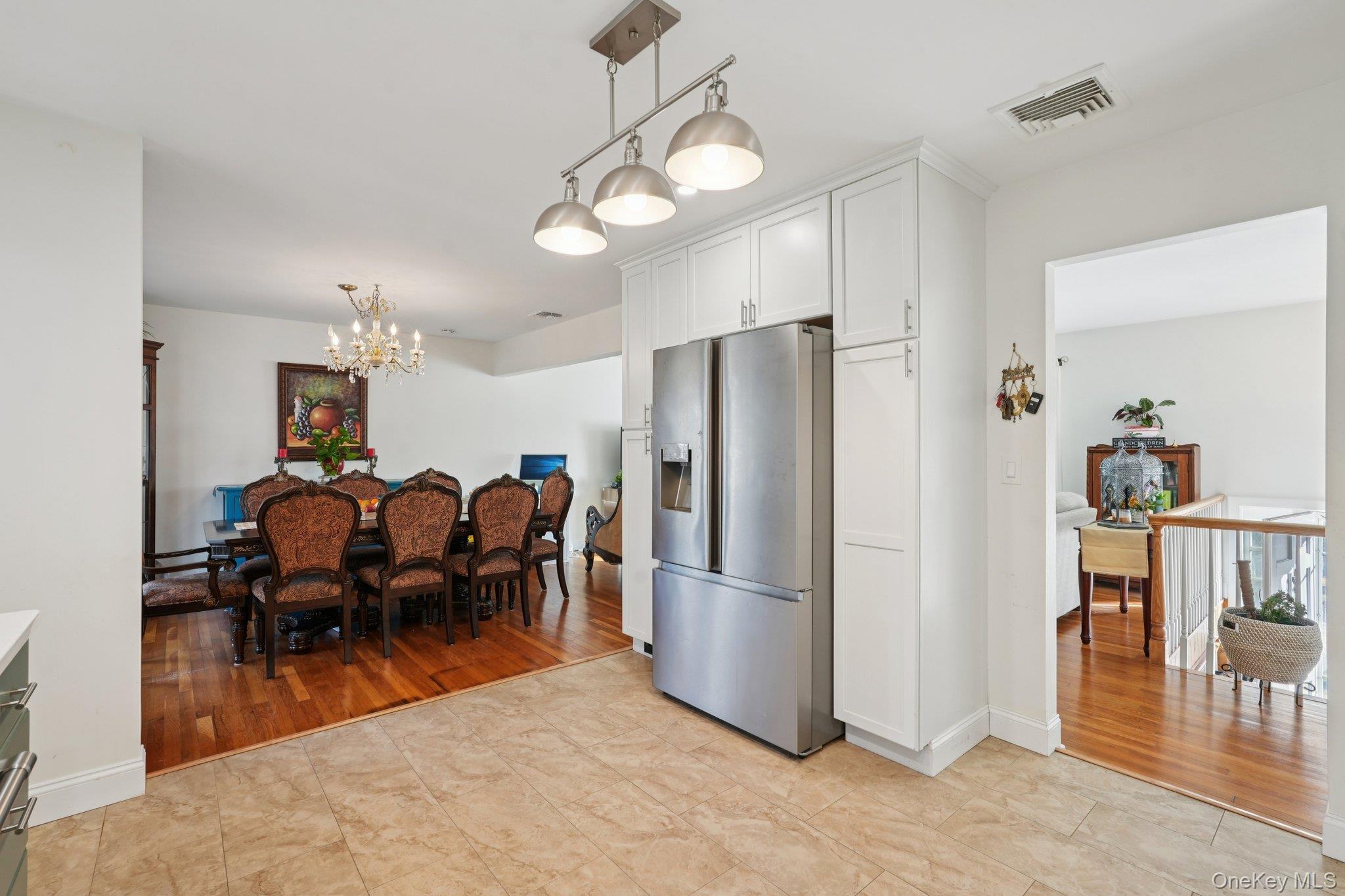 52 Pine Brook Road Monsey, NY 10952 - Photo 18 of 47 a kitchen with kitchen island a dining table chairs and refrigerator