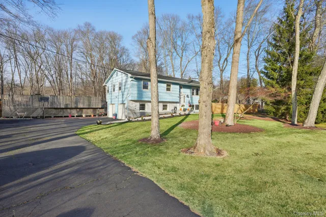 a living room with furniture a dining table and a chandelier