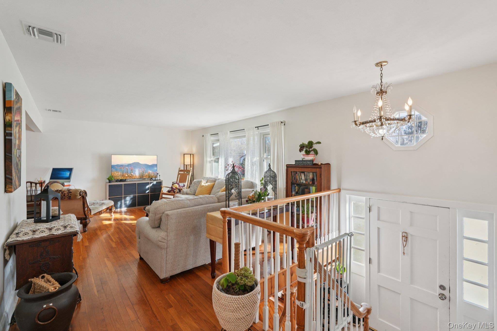 52 Pine Brook Road Monsey, NY 10952 - Photo 6 of 47 a living room with furniture a dining table and a chandelier