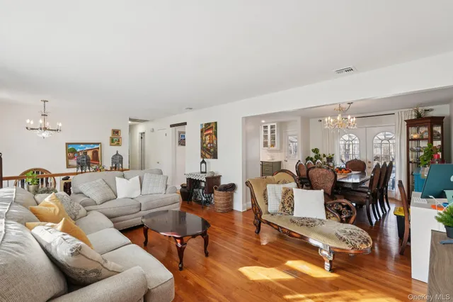 a view of a dining room with furniture wooden floor and chandelier