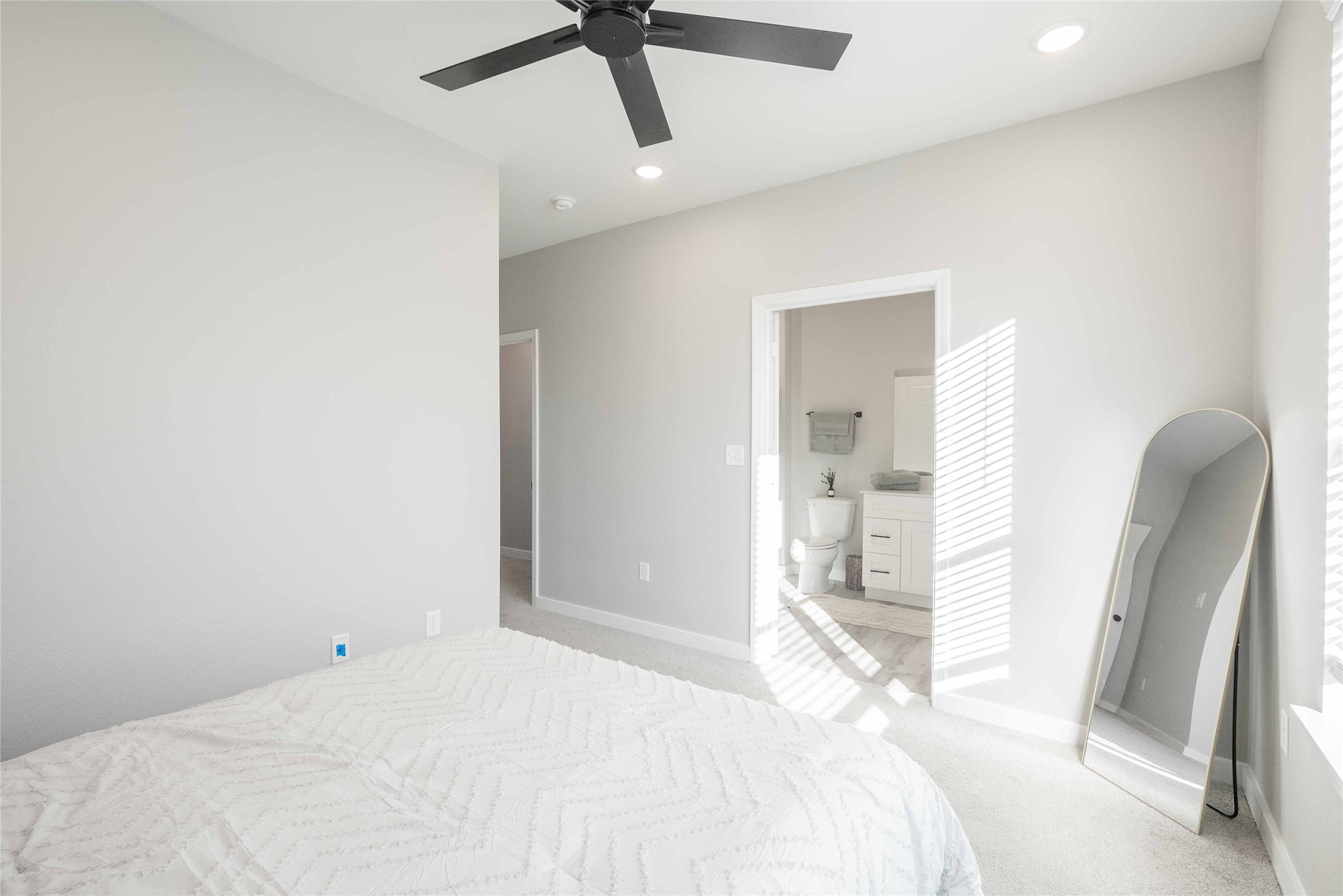 2101 Reinke Road, Unit 6103 Waller, TX 77484 - Photo 12 of 23 a bedroom with a bed and a large mirror