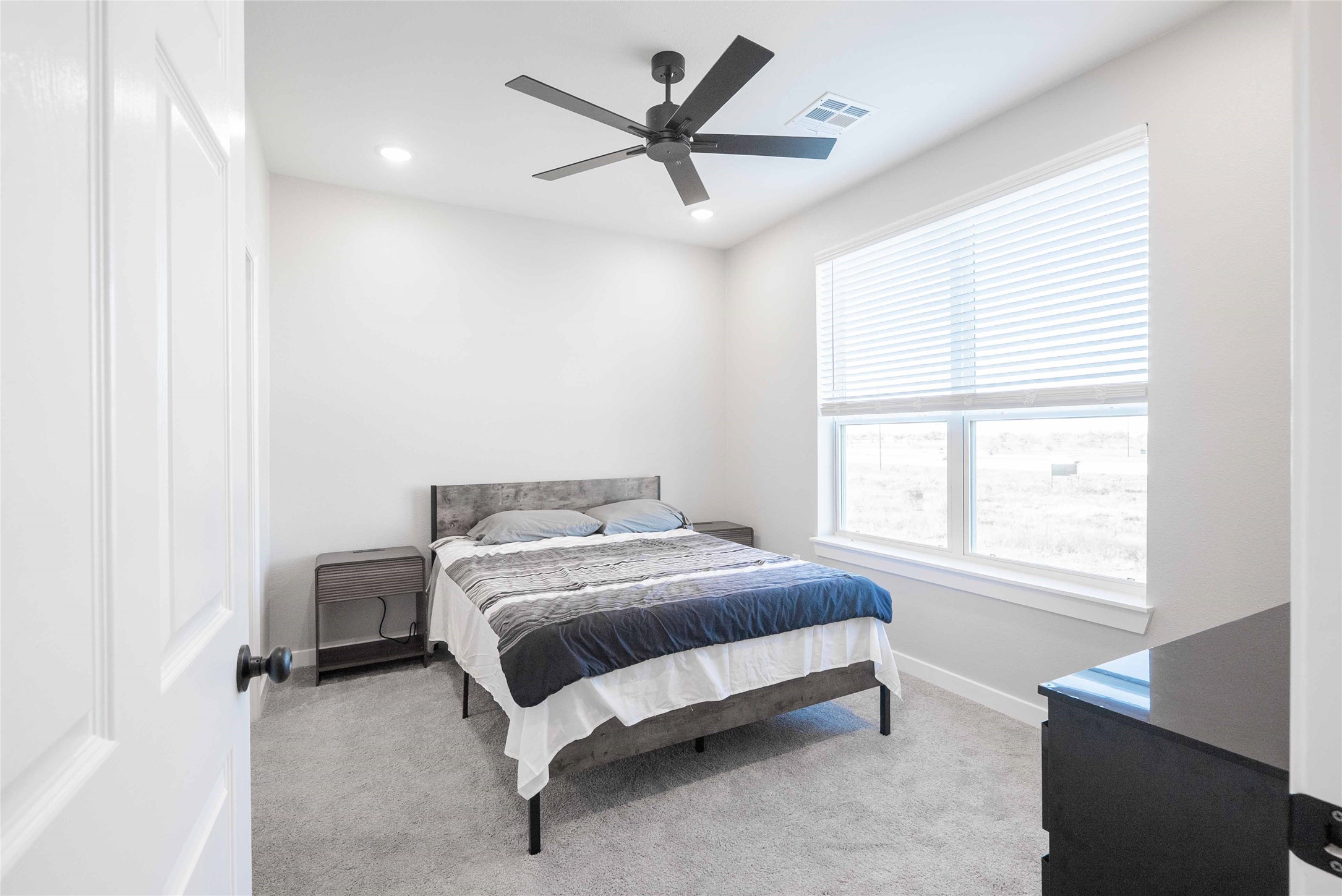 2101 Reinke Road, Unit 6103 Waller, TX 77484 - Photo 6 of 23 a bed sitting in a bedroom next to a window