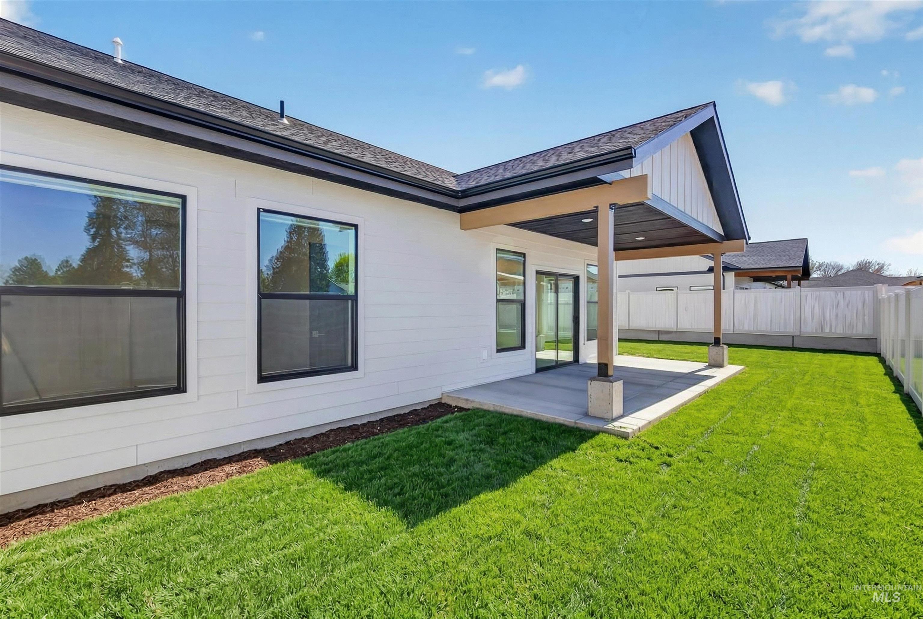3710 22nd Street Lewiston, ID 83501 - Photo 34 of 36 Back of property featuring a patio area, a shingled roof, and board and batten siding
