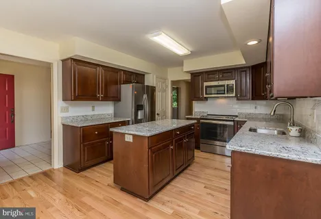 a view of a room with wooden floor fan and window