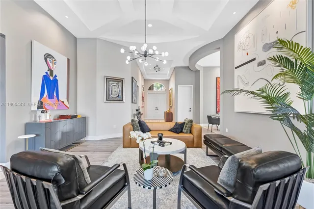 a living room with furniture and a chandelier