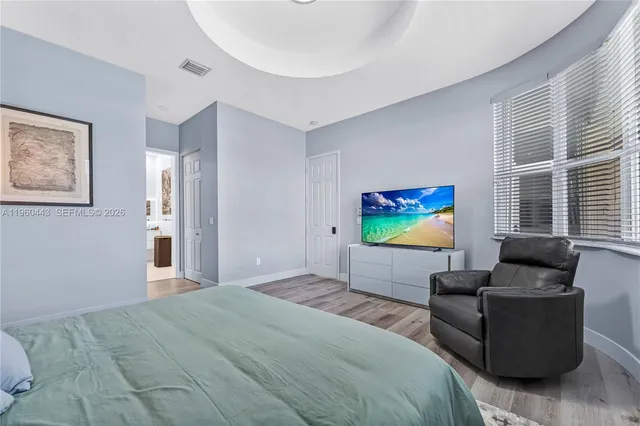 a bedroom with furniture and a large window