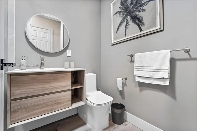 a bathroom with a toilet sink and mirror