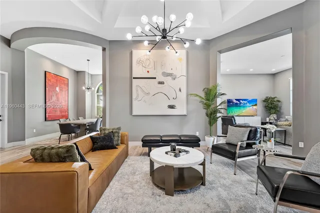 a living room with furniture and a chandelier