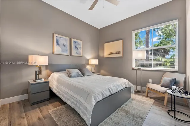 a bedroom with a bed a lamp and a window