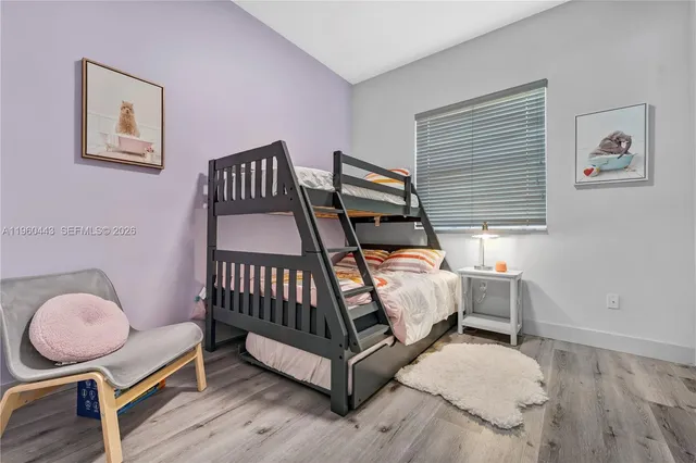 a bed room with a bed and chair