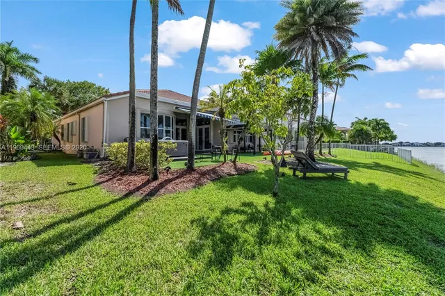 a house view with a sitting space garden and patio