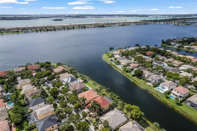 an aerial view of residential houses with outdoor space and lake view