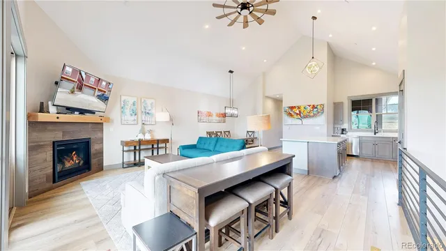 a living room with furniture ceiling fan and a rug