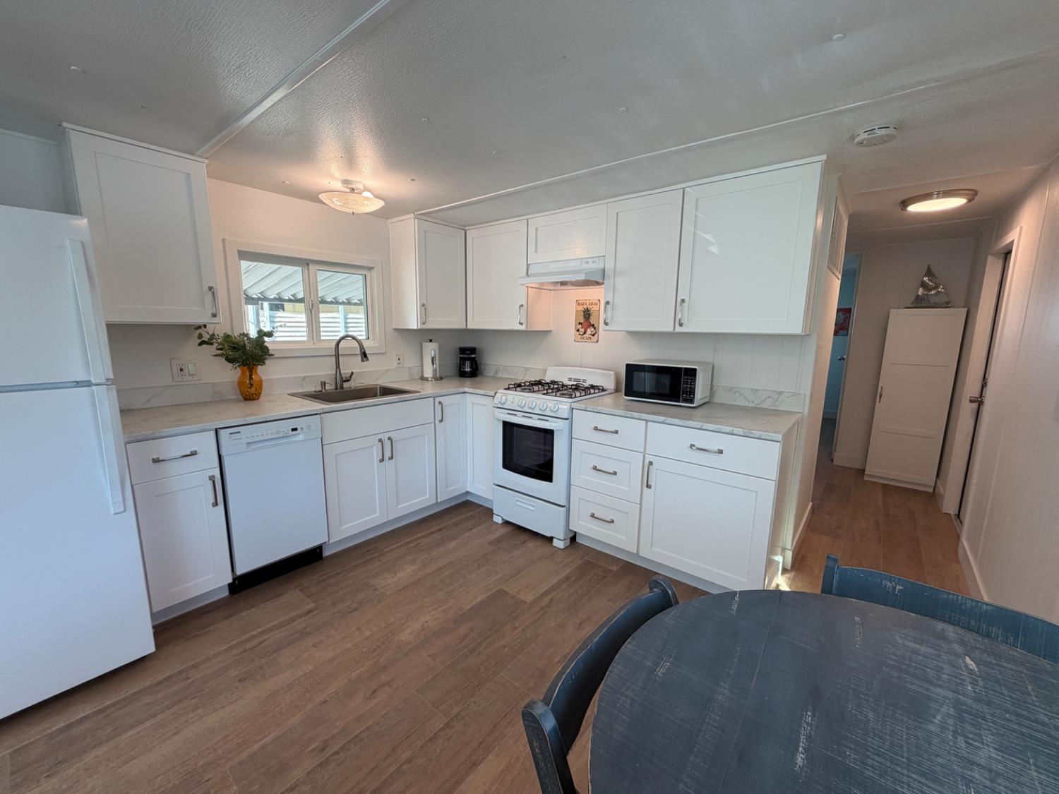 9060 Auburn Folsom Road, Unit 19 Granite Bay, CA 95746 - Photo 6 of 30 a kitchen with white cabinets sink and stainless steel appliances