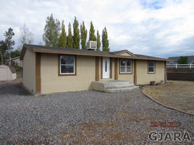 1752 L L 1/2 Road Fruita, CO 81521 - Photo 1 of 6 a house with trees in the background