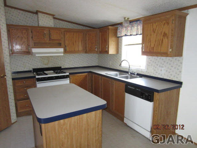 1752 L L 1/2 Road Fruita, CO 81521 - Photo 3 of 6 a kitchen with a sink cabinets and a window