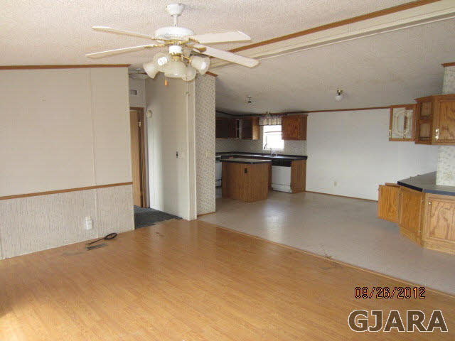 1752 L L 1/2 Road Fruita, CO 81521 - Photo 4 of 6 a kitchen with stainless steel appliances a refrigerator and a fireplace