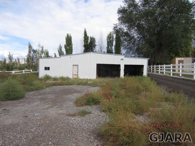 1752 L L 1/2 Road Fruita, CO 81521 - Photo 6 of 6 a view of a house with backyard and trees