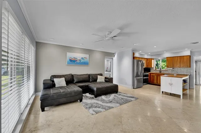 a living room with furniture and kitchen view