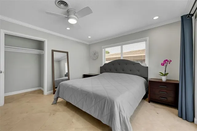 a bedroom with a bed and a window