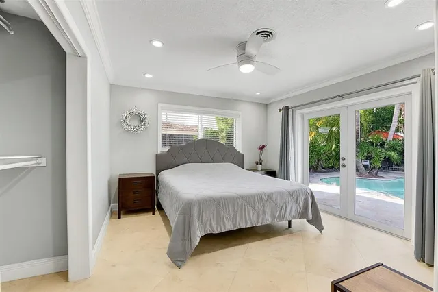 a bedroom with a large bed and a chandelier